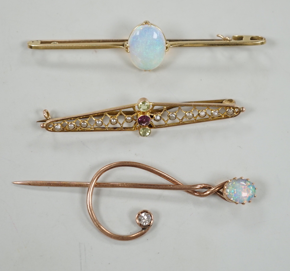 A novelty yellow metal, white opal and diamond set 'treble clef' stick pin, 60mm, a 15ct and white opal set bar brooch and one other 9ct and gem set brooch, gross weight 8.2 grams.